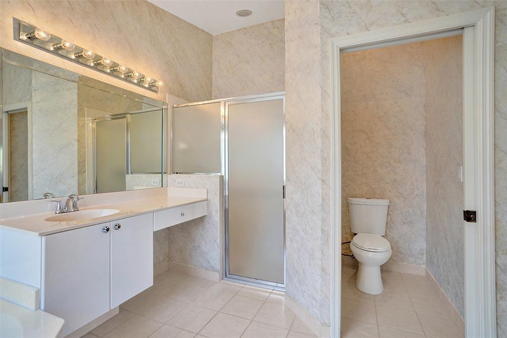 7219 Modena Drive Boynton Beach, FL 33437 - Photo 24 of 47 a bathroom with a double vanity sink toilet and shower