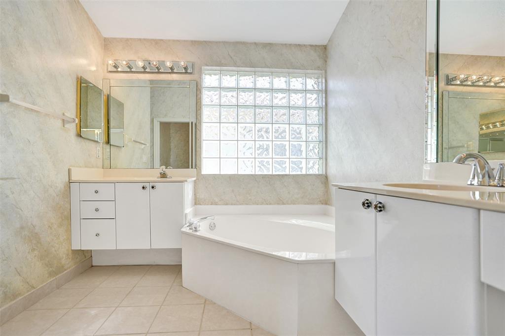 7219 Modena Drive Boynton Beach, FL 33437 - Photo 25 of 47 a bathroom with a tub sink and mirror