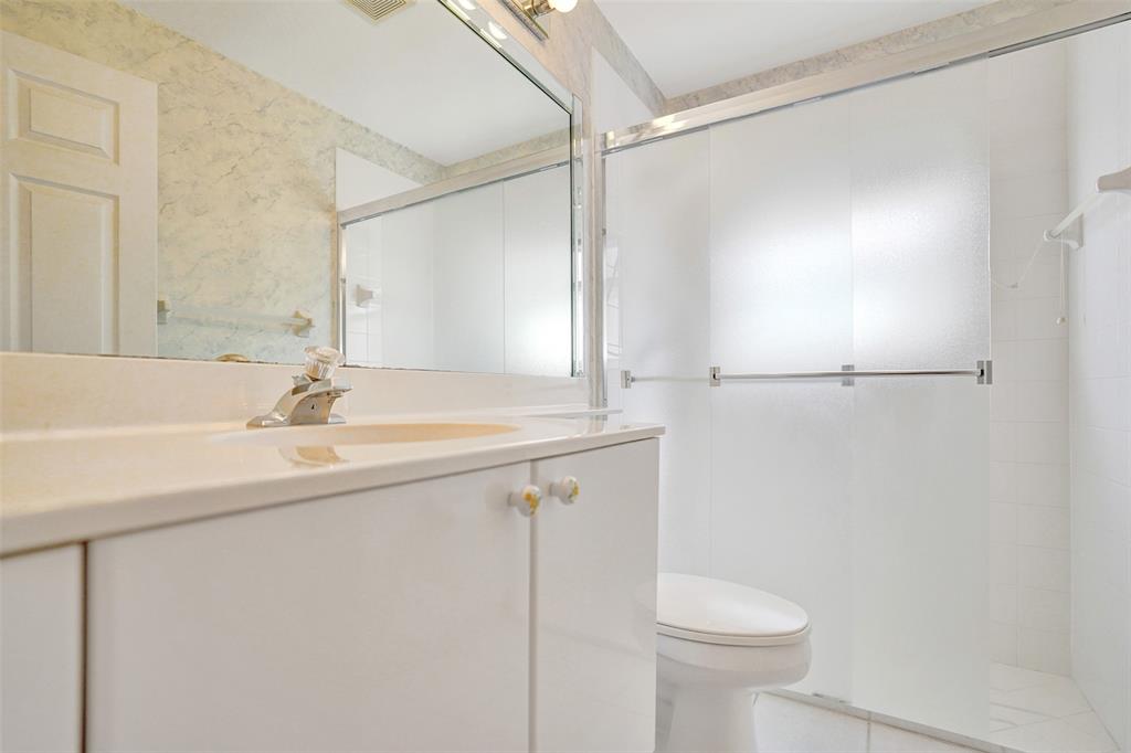 7219 Modena Drive Boynton Beach, FL 33437 - Photo 31 of 47 a bathroom with a sink a toilet and shower