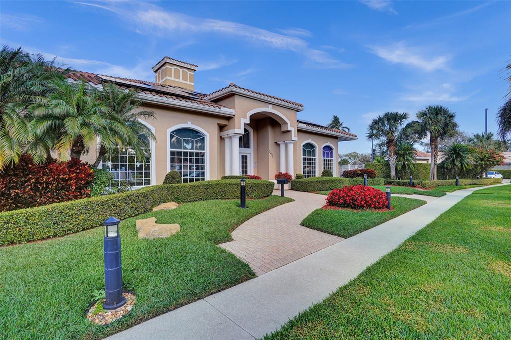 7219 Modena Drive Boynton Beach, FL 33437 - Photo 36 of 47 a front view of a house with a garden