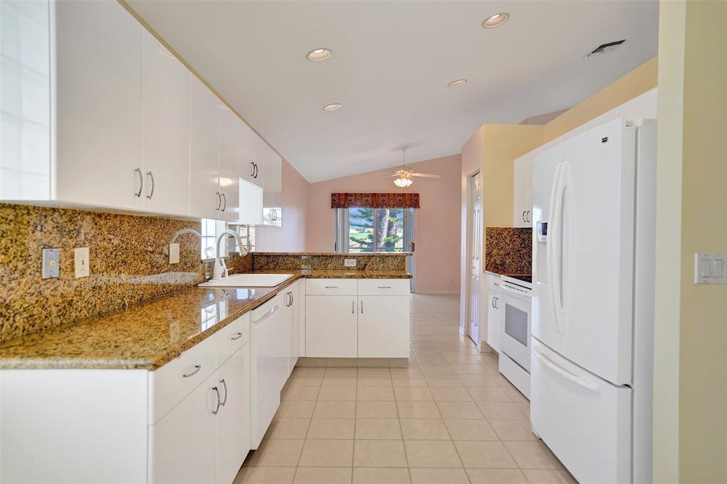 7219 Modena Drive Boynton Beach, FL 33437 - Photo 9 of 47 a large white kitchen with stainless steel appliances granite countertop a refrigerator and a sink
