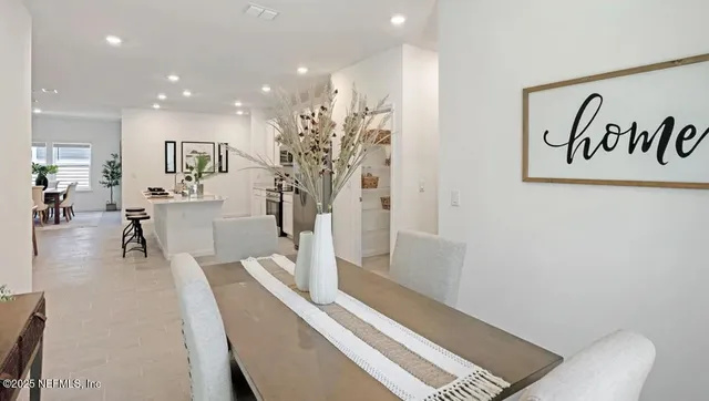 a kitchen with a table chairs and a counter top space