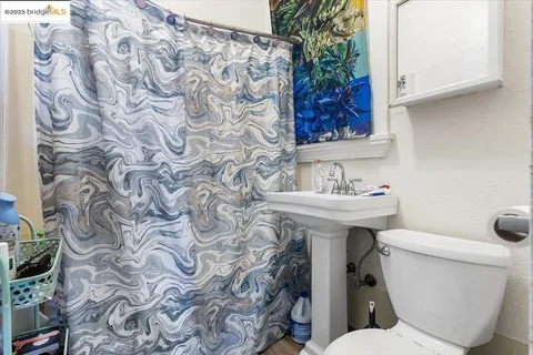 a bathroom with a sink and mirror with toilet
