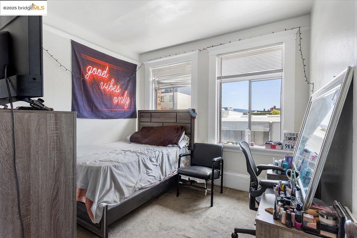 498 25th Street Oakland, CA 94612 - Photo 12 of 44 a bedroom with a bed and a flat screen tv