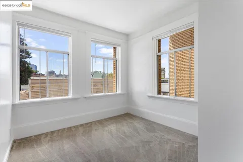 a view of room with window and wooden floor