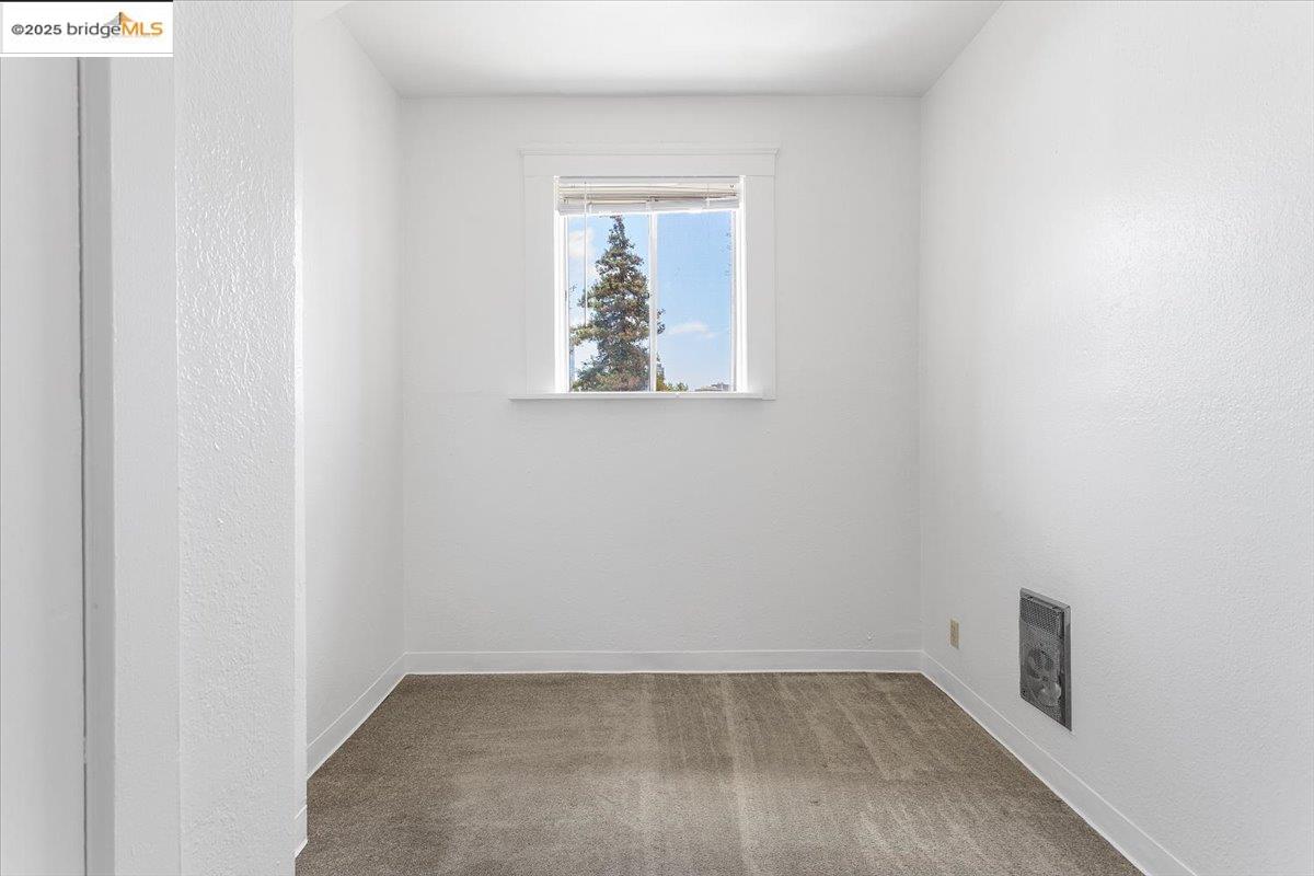 498 25th Street Oakland, CA 94612 - Photo 21 of 44 a view of an empty room with a window
