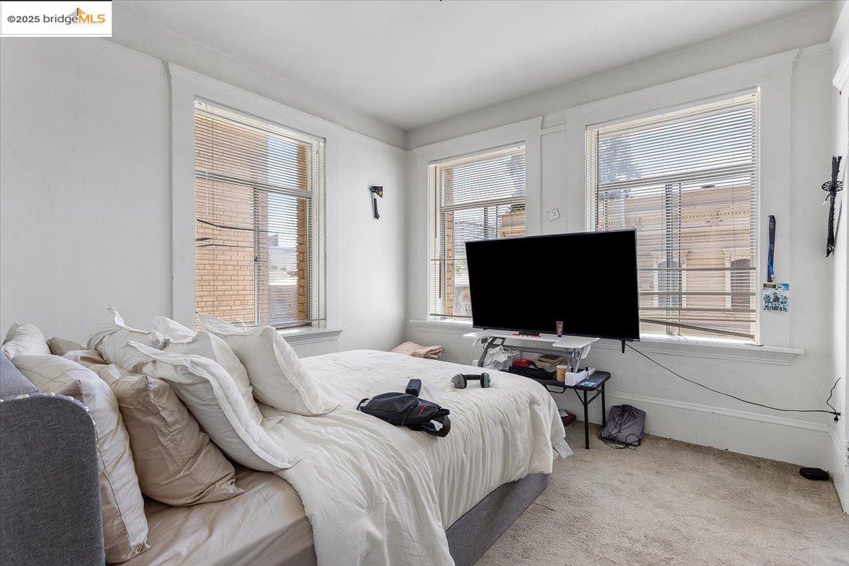 498 25th Street Oakland, CA 94612 - Photo 24 of 44 a bedroom with a bed and a flat screen tv