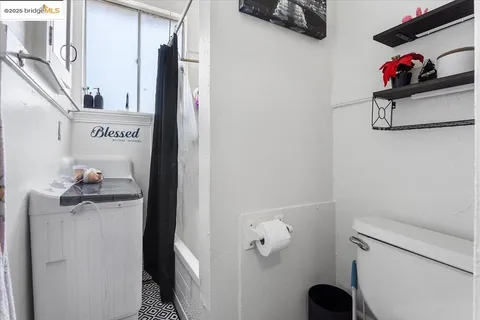 a bathroom with a toilet and a shower curtain