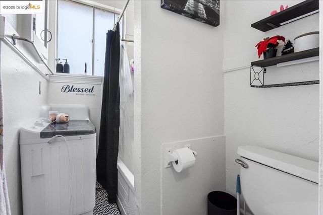 a bathroom with a toilet and a shower curtain