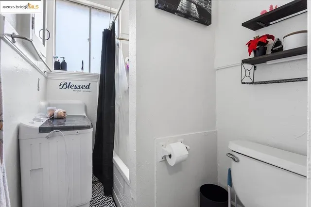 a bathroom with a toilet and a shower curtain