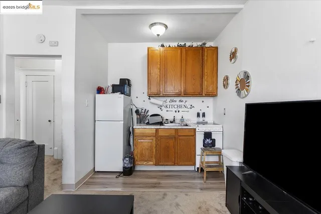 a living room with a bed furniture and a flat screen tv