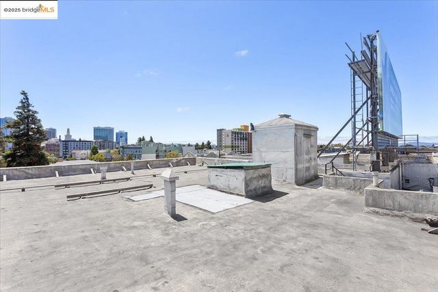 a view of roof deck with table and chairs