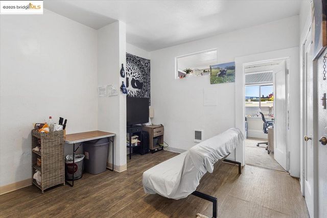 a bedroom with furniture and a wooden floor