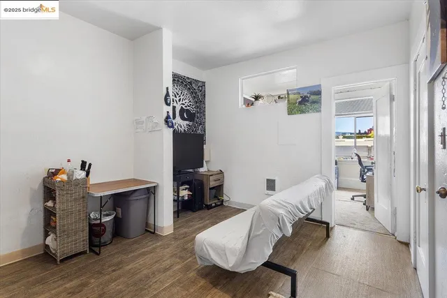 a bedroom with furniture and a wooden floor