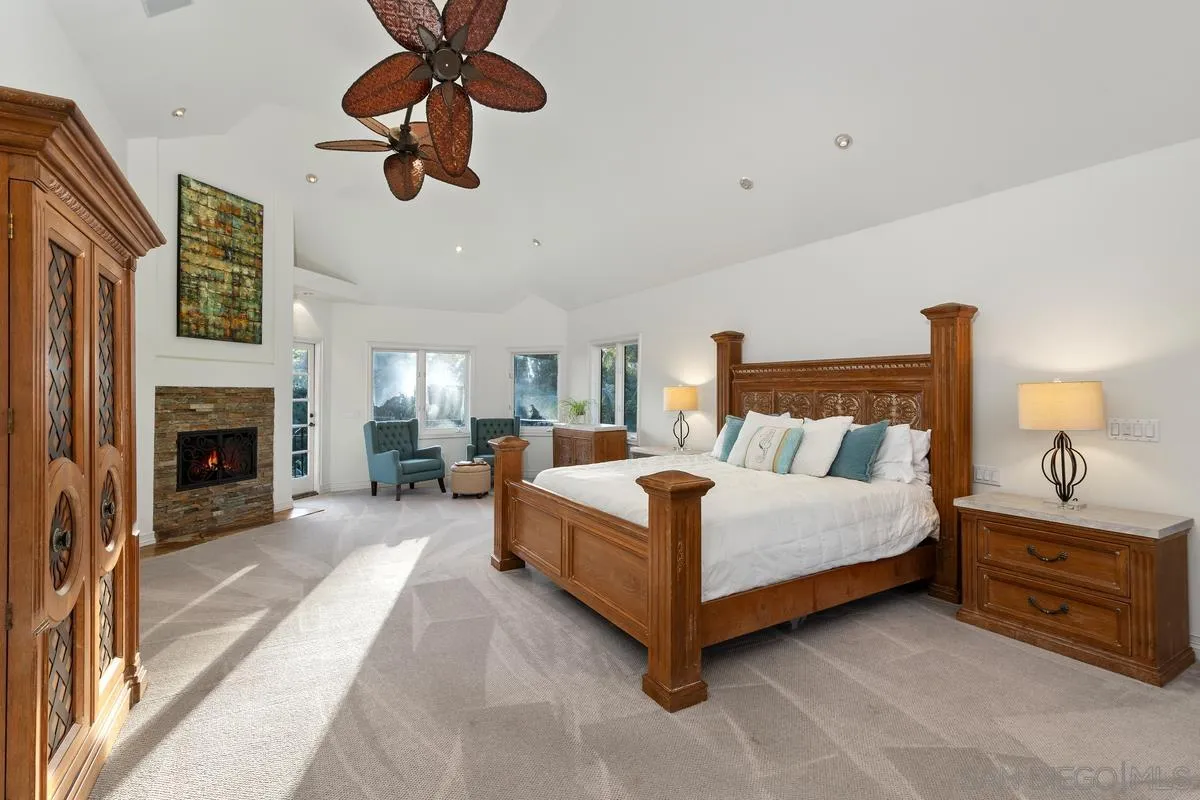 6281 Avenida Loma De Oro Rancho Santa Fe, CA 92067 - Photo 24 of 40 a bedroom with a bed and a fireplace