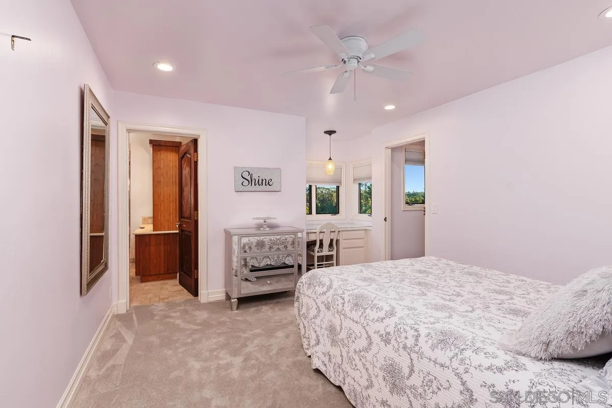 6281 Avenida Loma De Oro Rancho Santa Fe, CA 92067 - Photo 27 of 40 a spacious bedroom with a bed a dresser and potted plant on the dresser