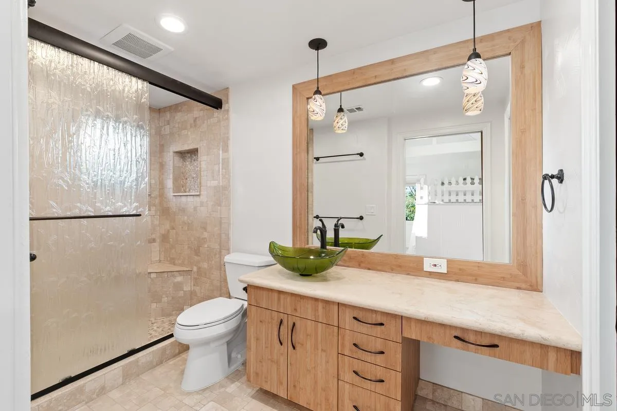 6281 Avenida Loma De Oro Rancho Santa Fe, CA 92067 - Photo 31 of 40 a bathroom with a granite countertop sink a toilet and shower