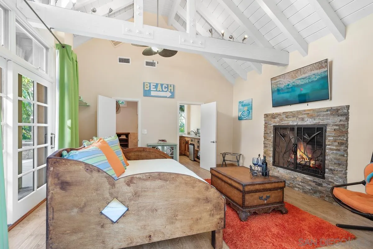 6281 Avenida Loma De Oro Rancho Santa Fe, CA 92067 - Photo 32 of 40 a living room with furniture fireplace and flat screen tv