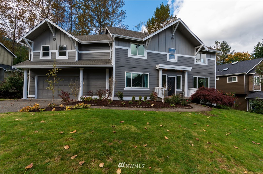 1220 Southwest 12th Street North Bend, WA 98045 - Photo 2 of 25 a front view of a house with a garden and trees