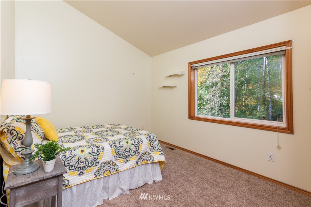 1220 Southwest 12th Street North Bend, WA 98045 - Photo 14 of 25 a bedroom with a bed and a window