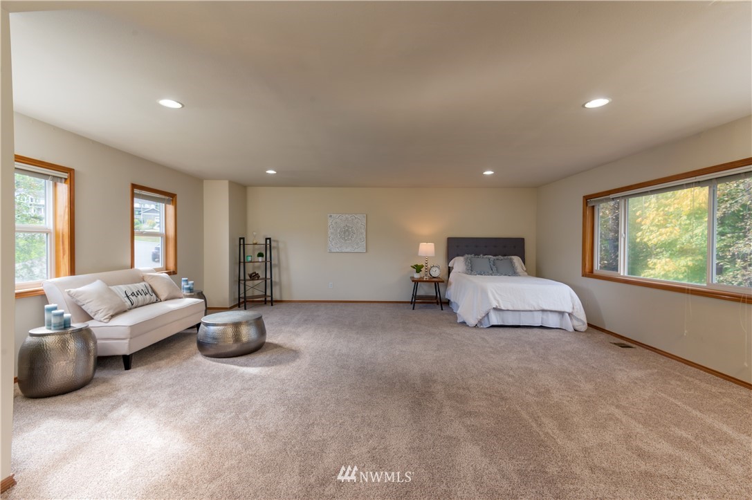1220 Southwest 12th Street North Bend, WA 98045 - Photo 15 of 25 a spacious bedroom with a bed and a large window