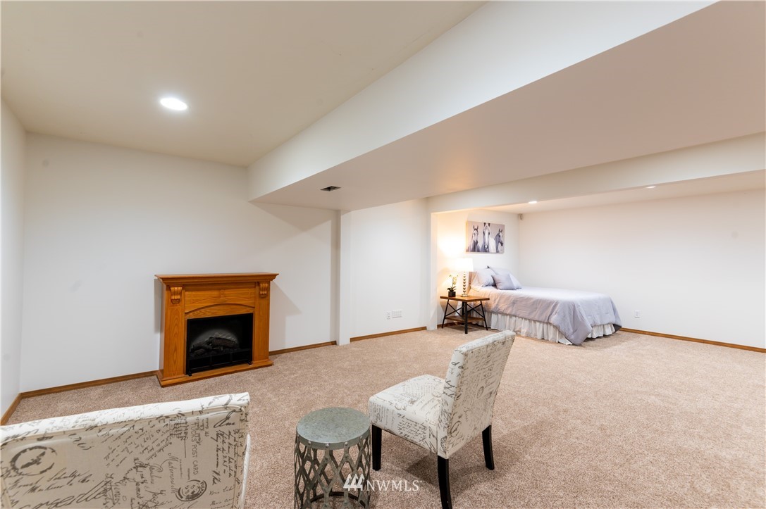 1220 Southwest 12th Street North Bend, WA 98045 - Photo 19 of 25 a bedroom with furniture and a fireplace