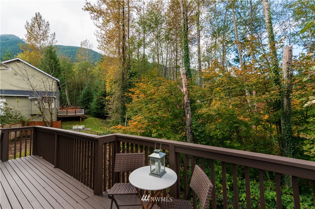 1220 Southwest 12th Street North Bend, WA 98045 - Photo 20 of 25 a balcony with wooden floor and outdoor seating