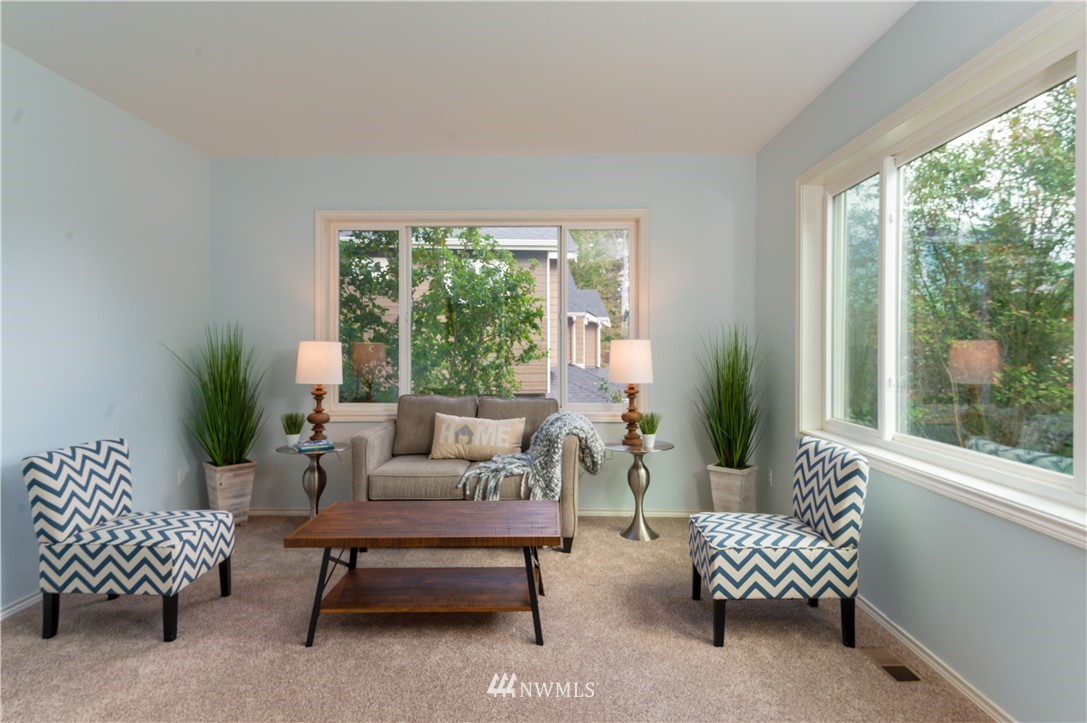 1220 Southwest 12th Street North Bend, WA 98045 - Photo 3 of 25 a living room with furniture and a large window with garden view