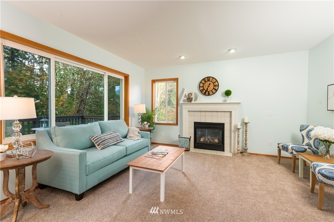 1220 Southwest 12th Street North Bend, WA 98045 - Photo 9 of 25 a living room with furniture and a fireplace
