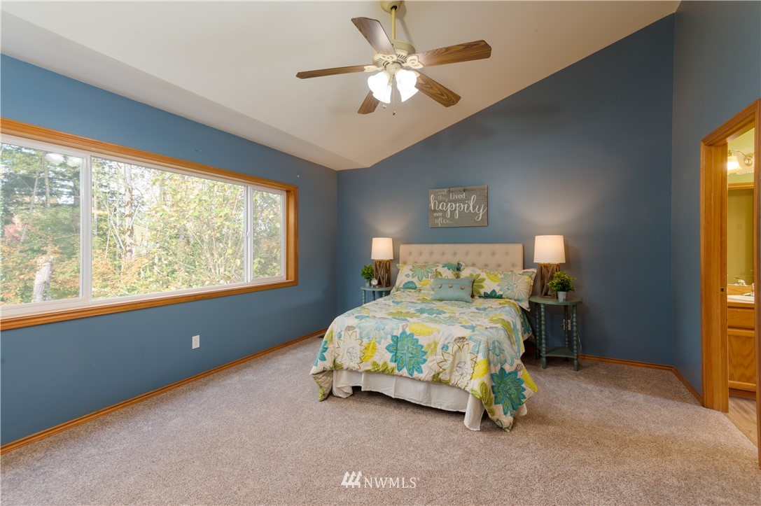 1220 Southwest 12th Street North Bend, WA 98045 - Photo 10 of 25 a bedroom with a bed and a chandelier