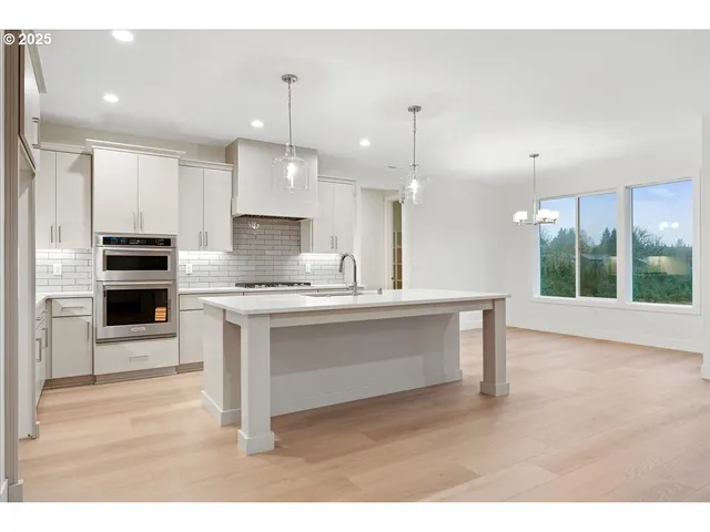 a kitchen with kitchen island a sink stainless steel appliances and cabinets