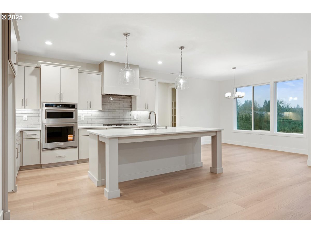 3510 North 11th Circle Ridgefield, WA 98642 - Photo 11 of 47 a kitchen with kitchen island a sink stainless steel appliances and cabinets