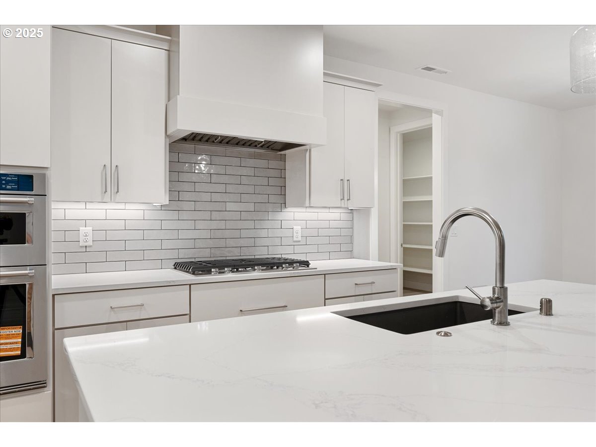 3510 North 11th Circle Ridgefield, WA 98642 - Photo 12 of 47 a kitchen with stainless steel appliances a sink and a stove