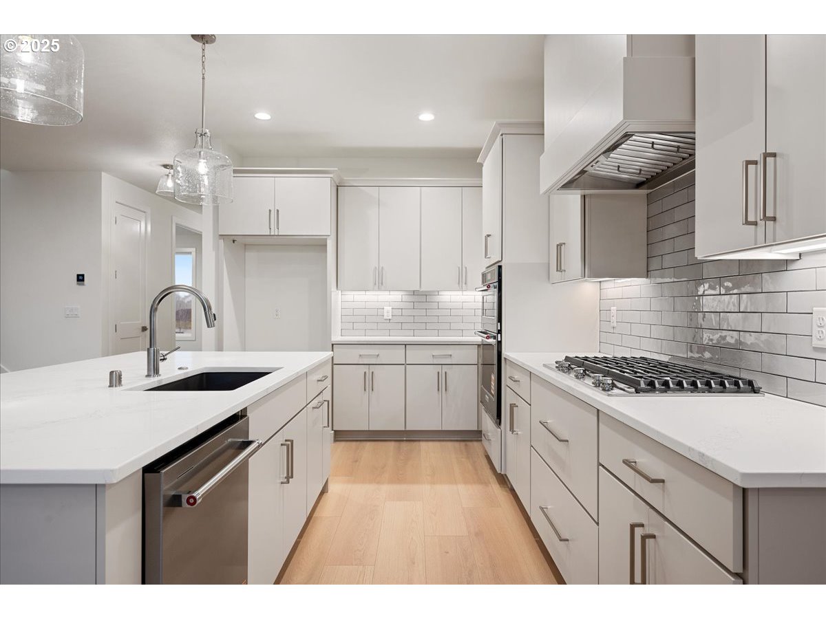 3510 North 11th Circle Ridgefield, WA 98642 - Photo 16 of 47 a kitchen with a sink stove and cabinets