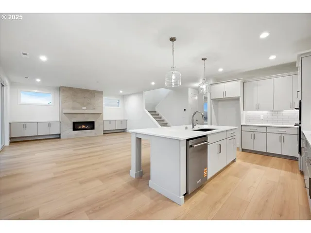 a kitchen with a sink stainless steel appliances and cabinets