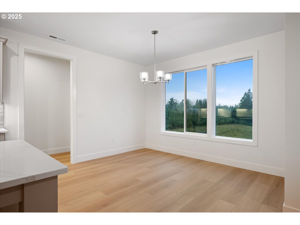 3510 North 11th Circle Ridgefield, WA 98642 - Photo 18 of 47 a view of a kitchen with wooden floor and a window