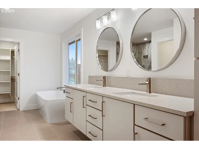 a bathroom with a double vanity sink and a mirror