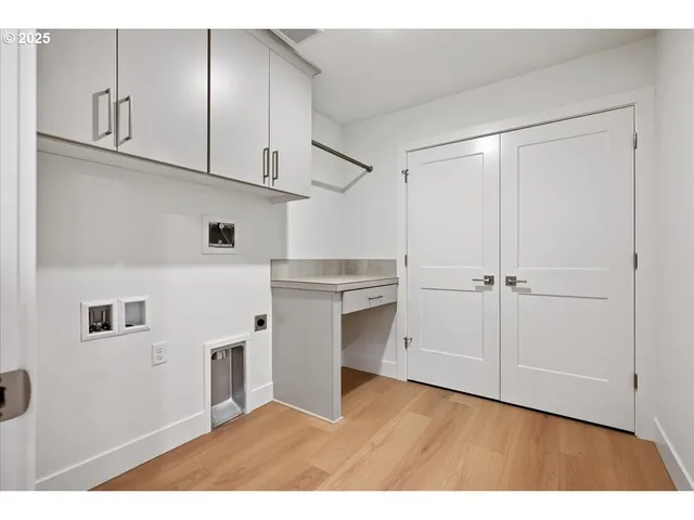 a kitchen with cabinets and wooden floor