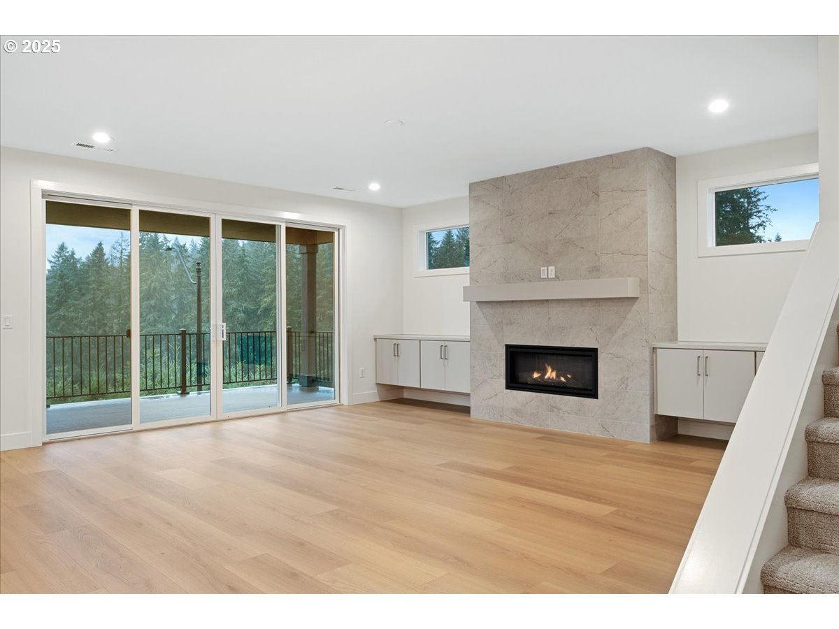 3510 North 11th Circle Ridgefield, WA 98642 - Photo 5 of 47 a view of an empty room with a fireplace and a large window