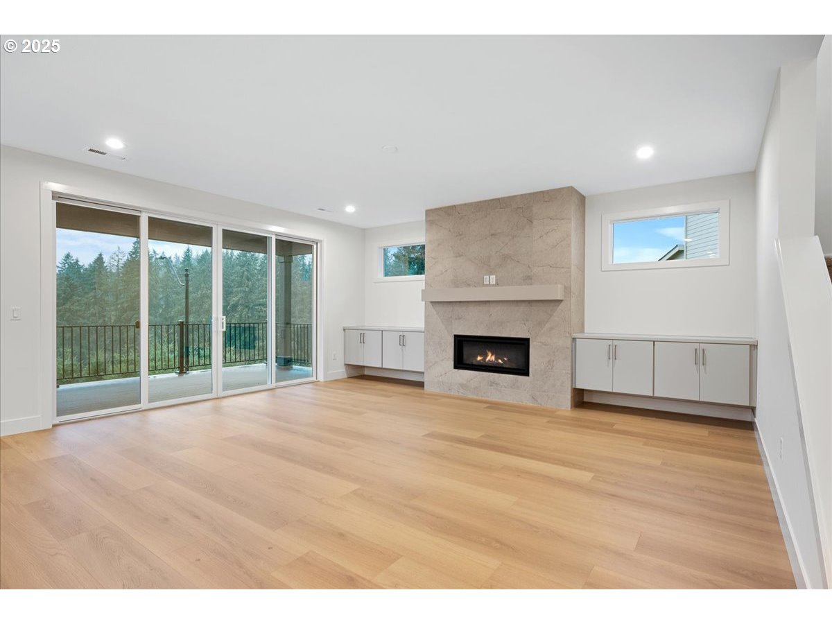 3510 North 11th Circle Ridgefield, WA 98642 - Photo 6 of 47 a view of an empty room with a fireplace and a large window
