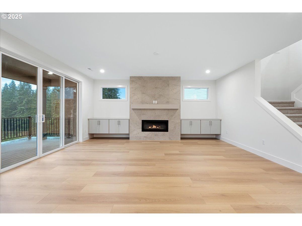 3510 North 11th Circle Ridgefield, WA 98642 - Photo 7 of 47 a view of empty room with wooden floor and fireplace