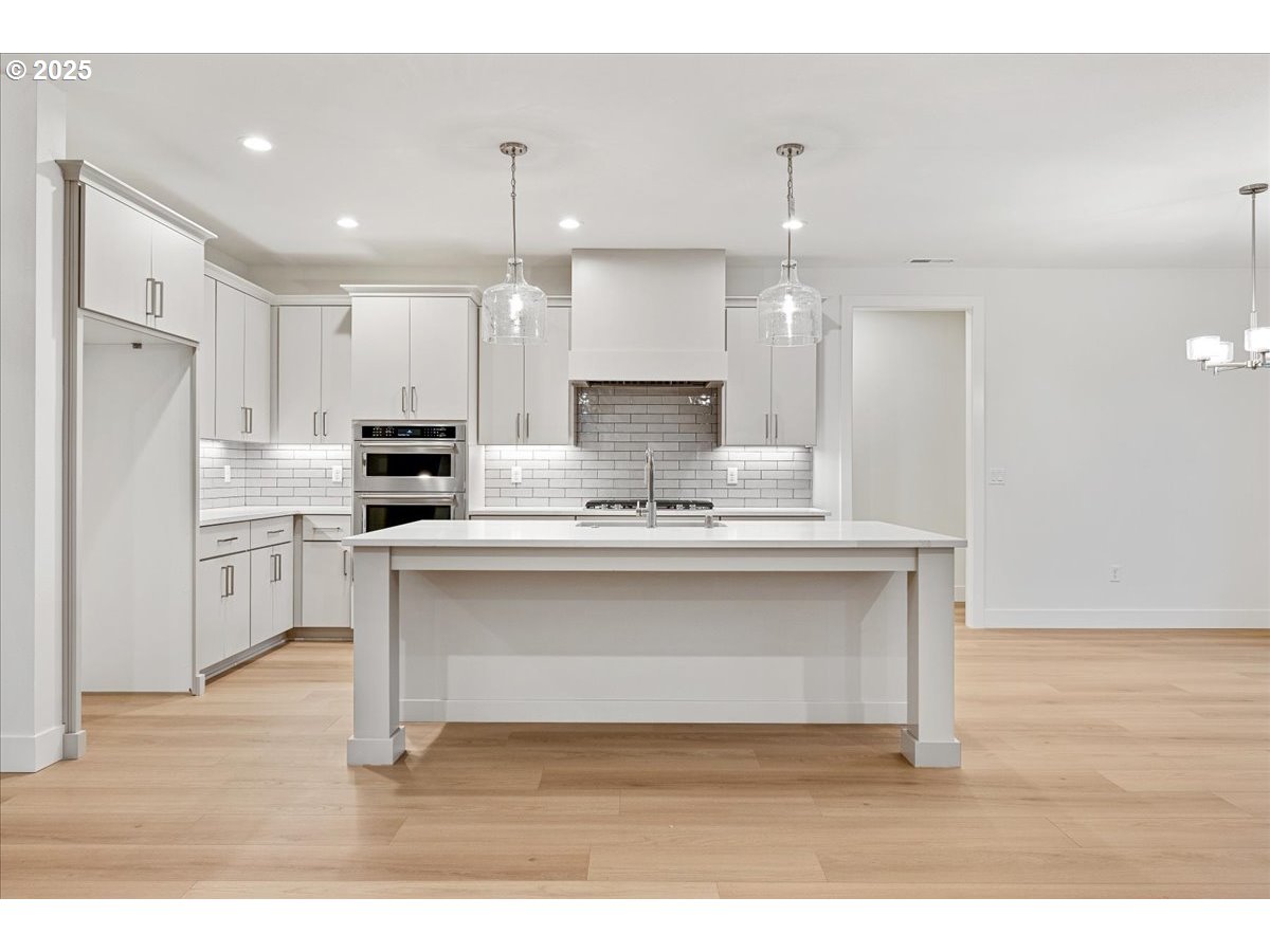 3510 North 11th Circle Ridgefield, WA 98642 - Photo 10 of 47 a kitchen with kitchen island a sink stainless steel appliances and cabinets