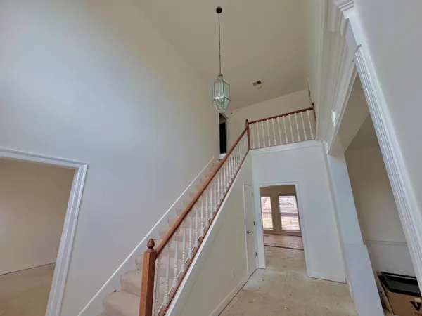 a spacious bedroom with a bed and a flat screen tv