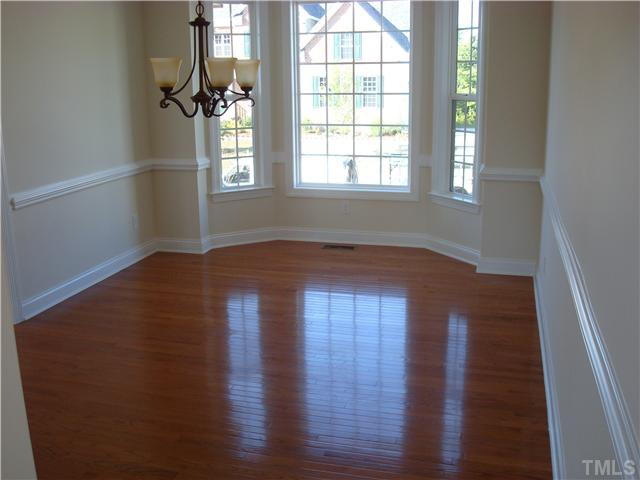 607 Ivyshaw Road Cary, NC 27519 - Photo 6 of 25 Dining room with bay window, hardwood floors, and trim