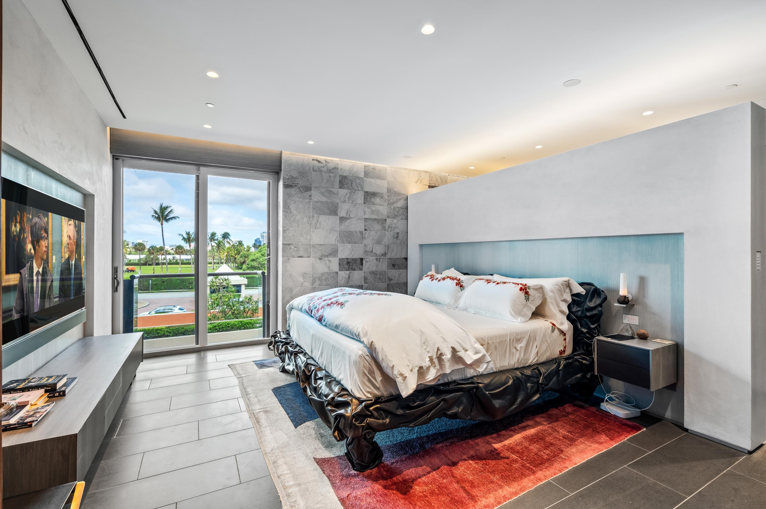 2 North Breakers Row, Unit N25 Palm Beach, FL 33480 - Photo 23 of 79 a bedroom with a bed and glass door