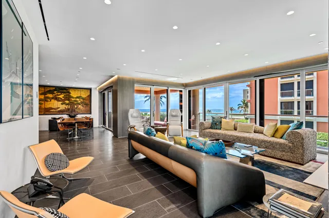 a living room with furniture and floor to ceiling windows