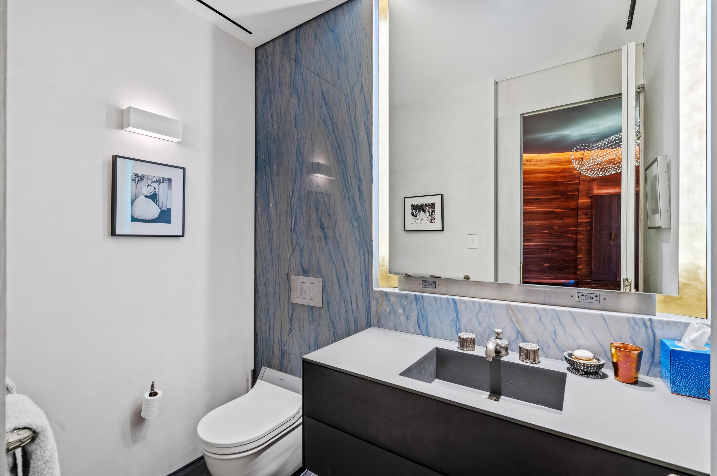 2 North Breakers Row, Unit N25 Palm Beach, FL 33480 - Photo 32 of 79 a bathroom with a toilet sink vanity and mirror