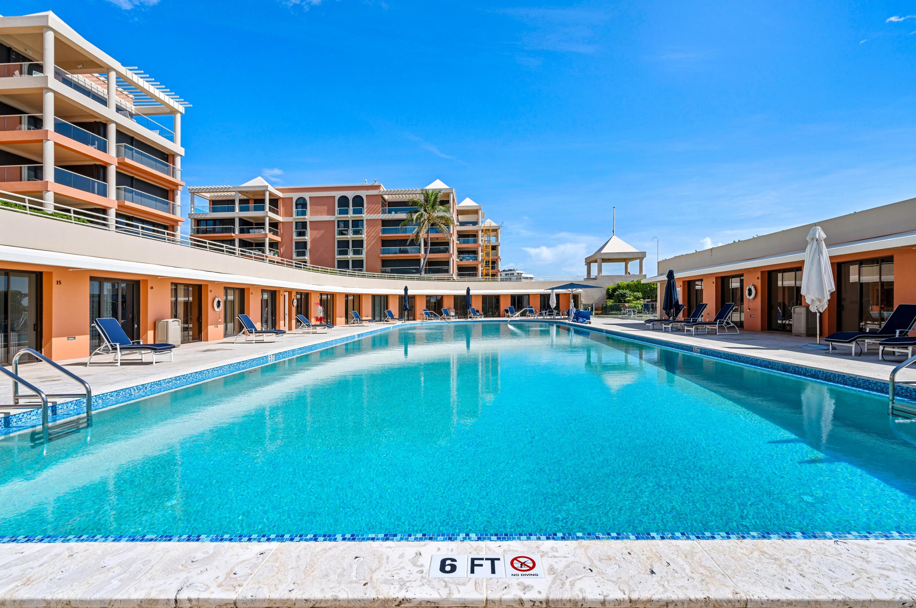 2 North Breakers Row, Unit N25 Palm Beach, FL 33480 - Photo 68 of 79 a view of swimming pool with lawn chairs and large tree
