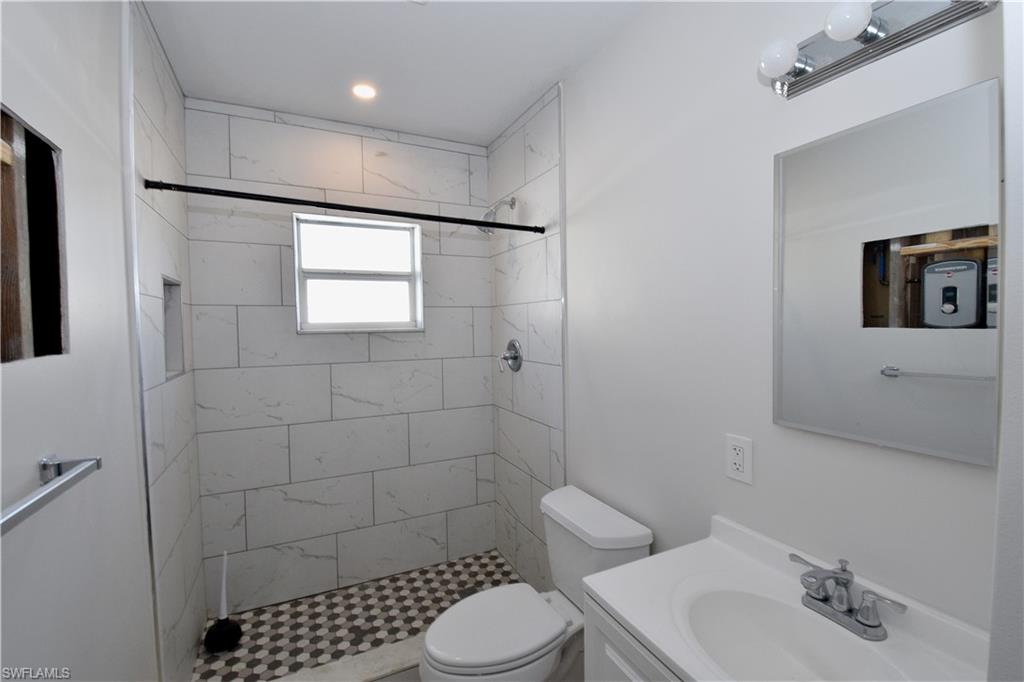 3125 Barrett Avenue Naples, FL 34112 - Photo 6 of 14 a bathroom with a sink toilet and shower