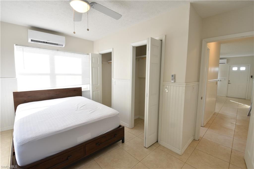 3125 Barrett Avenue Naples, FL 34112 - Photo 7 of 14 a room with a bed and a chandelier